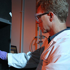Chemist examines uranium ore concentrate sample